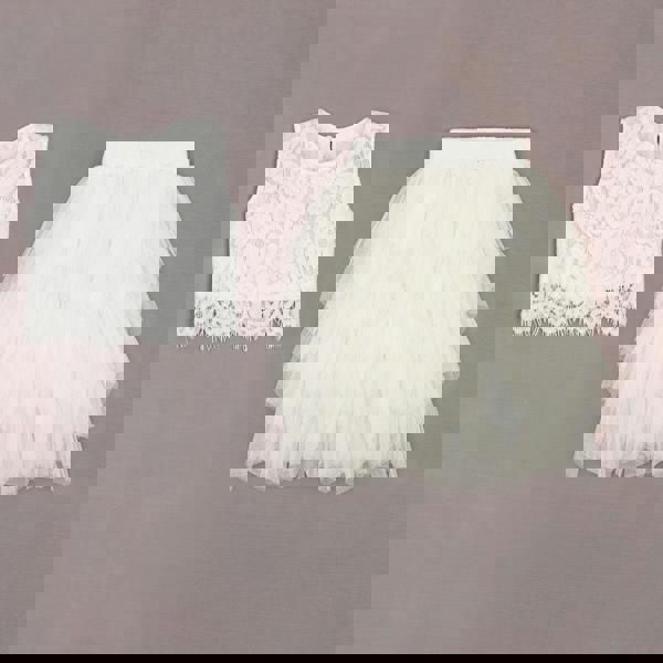 White lace top and tulle skirt on a gray background