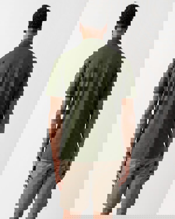 back of a model wearing a HUGO Deabono Mens Interlock Cotton Polo Shirt with Stacked Logo in Dark Green