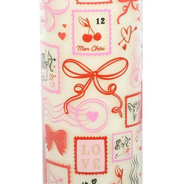 Close-up of Valentine tube candle label with cherries, hearts, and bow stamp design