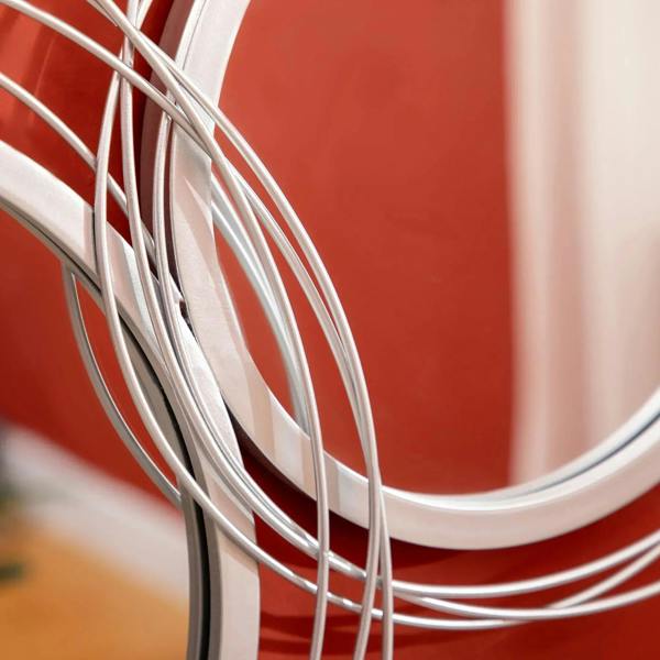 Silver metal mirror ring frames close-up with polished chrome curves and reflective glass