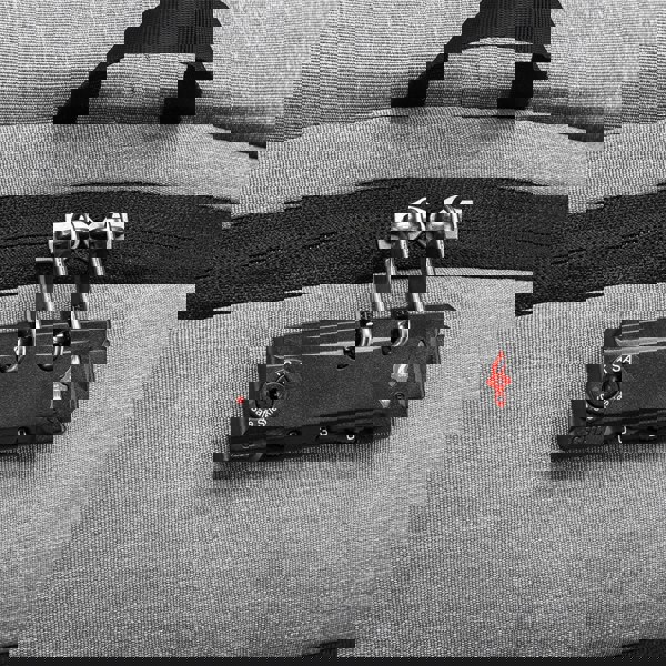 Close-up of a gray suitcase with a TSA-approved lock on a matching gray background best travel laptop backpack multi-functional