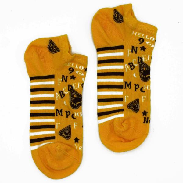 Pair of yellow low-cut socks with black stripes and Ouija board letter symbols