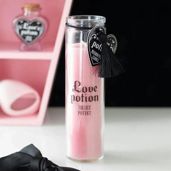 Pink tube candle with screw-top lid, black tassel charm and Love potion label