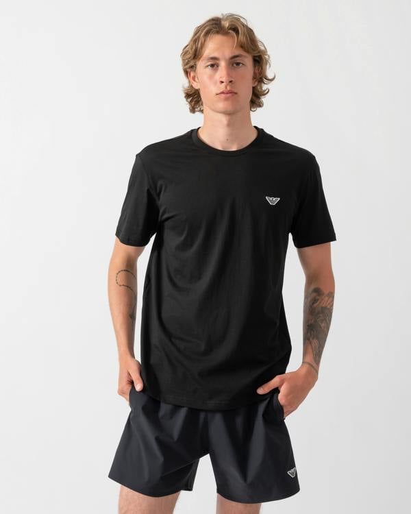 model wearing an Emporio Armani Mens Beach T-Shirt with Eagle Logo in Black