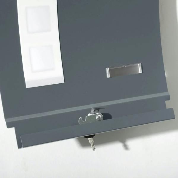 Close-up of anthracite gray mailbox front with nameplate slot and key lock below