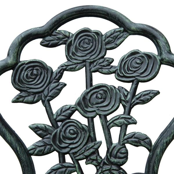 Close-up of antique green cast aluminum chair back with rose floral relief design.