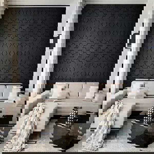 Modern living room with a hexagonal black wall pattern and a beige sectional sofa.