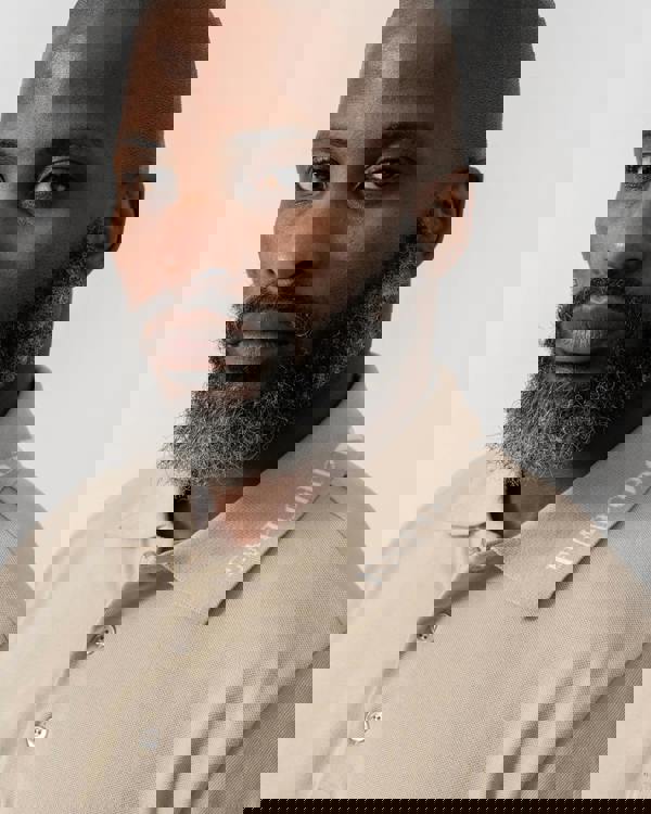 Model wearing Emporio Armani Mens Beach Polo in Taupe - Collar Detail