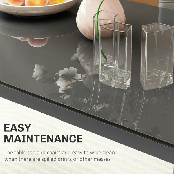 Grey glass tabletop with dining items; easy-wipe table surface with metal frame