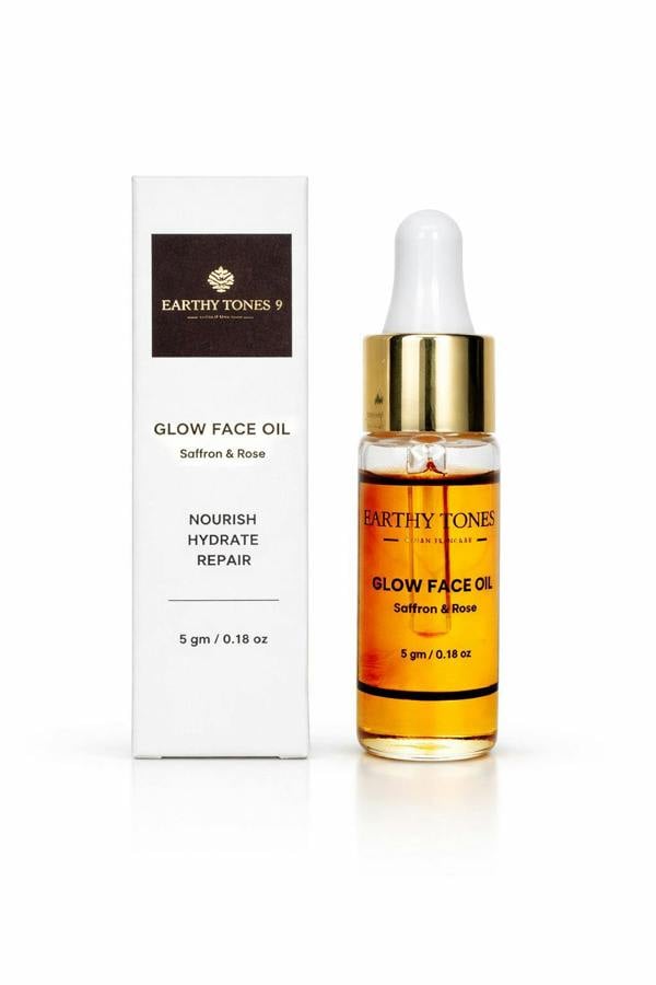 Earthly Tones Glow Face Oil bottle with dropper and packaging on a white background