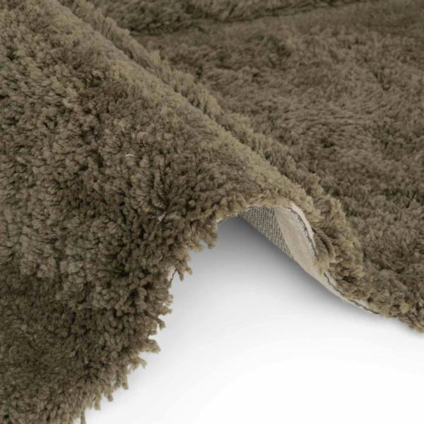Close-up of a brown textured rug corner on a white background