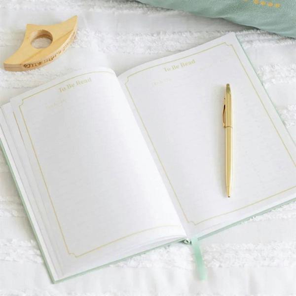 Open A5 reading journal with blank sections labeled 'To be read' and gold borders.