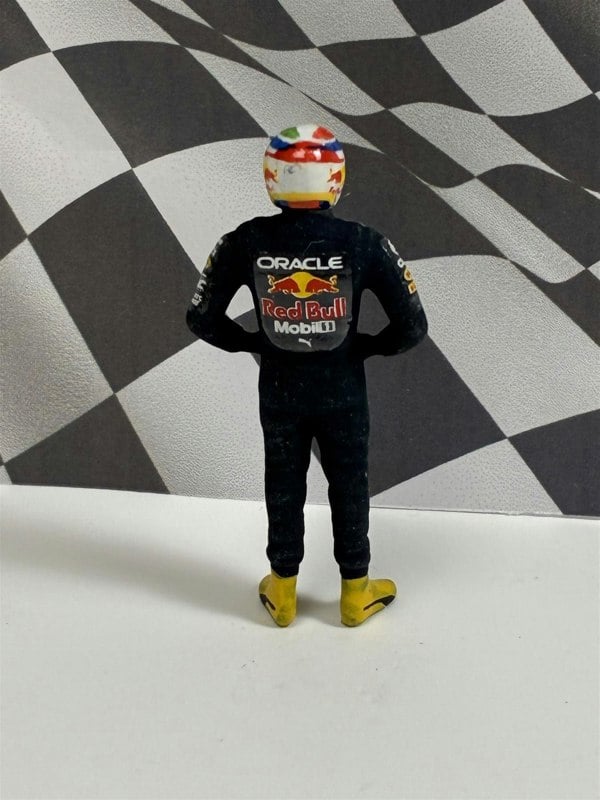 a toy figure of a man wearing a helmet and yellow boots