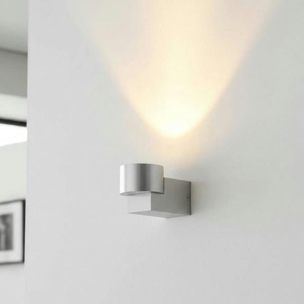 Silver indoor wall uplight in a modern home on a grey wall