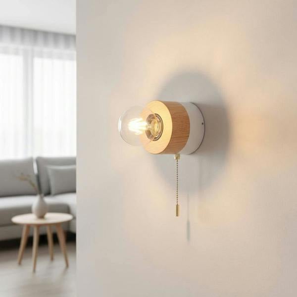 White finish interior LED wall light with pull cord on a plain wall in a modern home