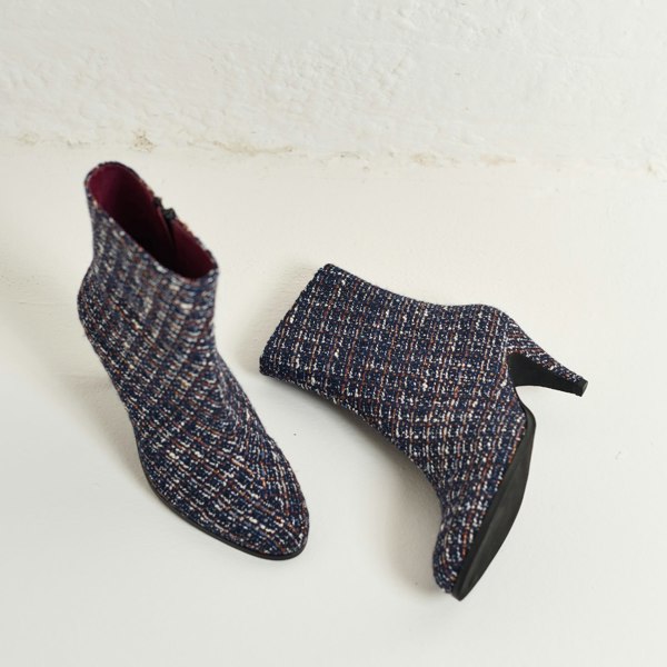 Pair of Maya tweed ankle boots on a light background