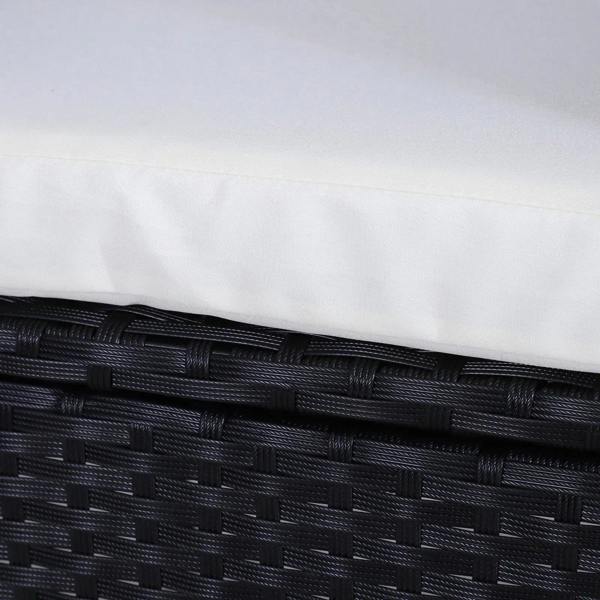 Black woven rattan frame with cream cushion cover edge close-up