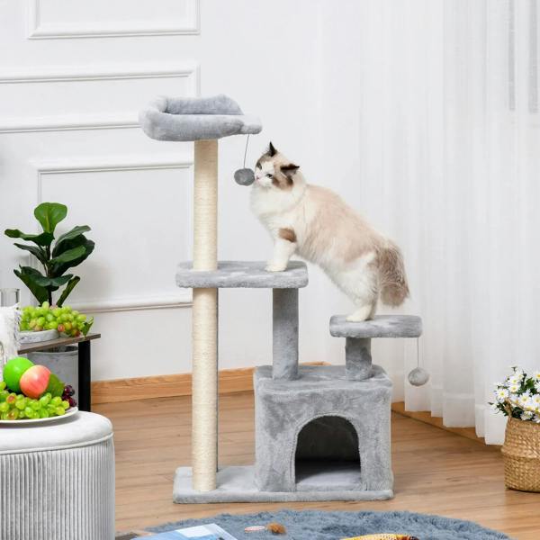 Light grey cat tree tower with plush platforms, cubby house, and hanging ball, cat sitting
