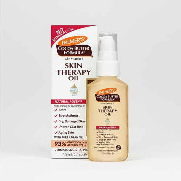Palmer's Cocoa Butter Formula Skin Therapy Oil in a clear bottle with a white pump, packaged with a box that has images highlighting the product's benefits like smoothing skin, reducing stretch marks, and improving skin tone.