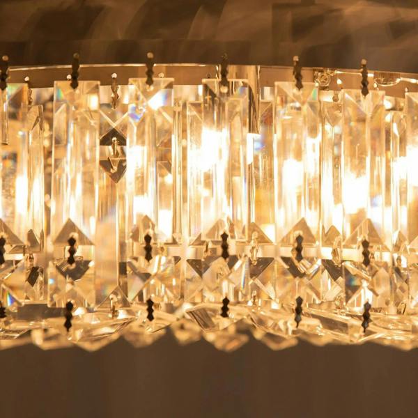 Close-up view of illuminated crystal prisms on a round ceiling light canopy