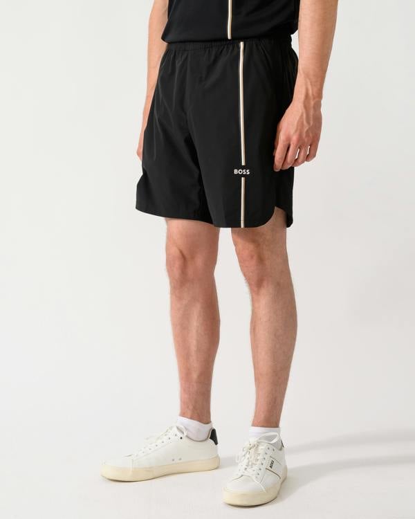 side shot of a model wearing a BOSS Green TOC Mens Active Tennis Shorts in Innovative NOVA Fabric in Black 001