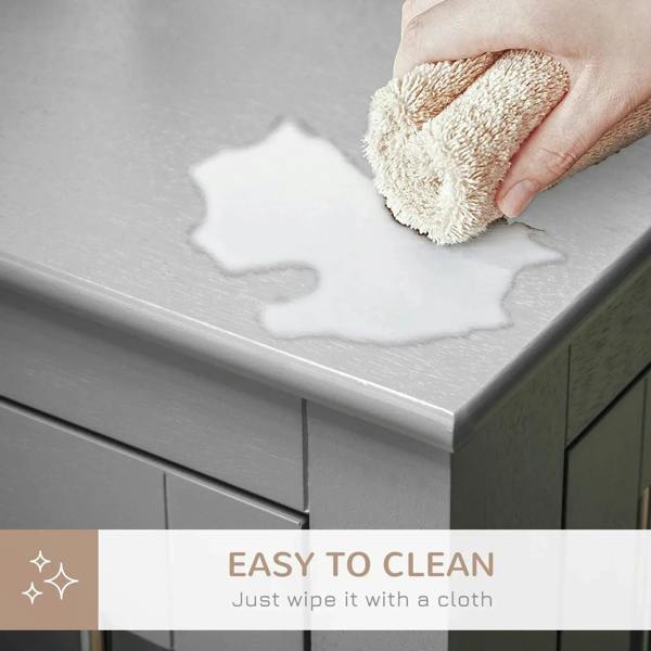 Grey dog crate end table top surface being wiped with a cloth for easy cleaning