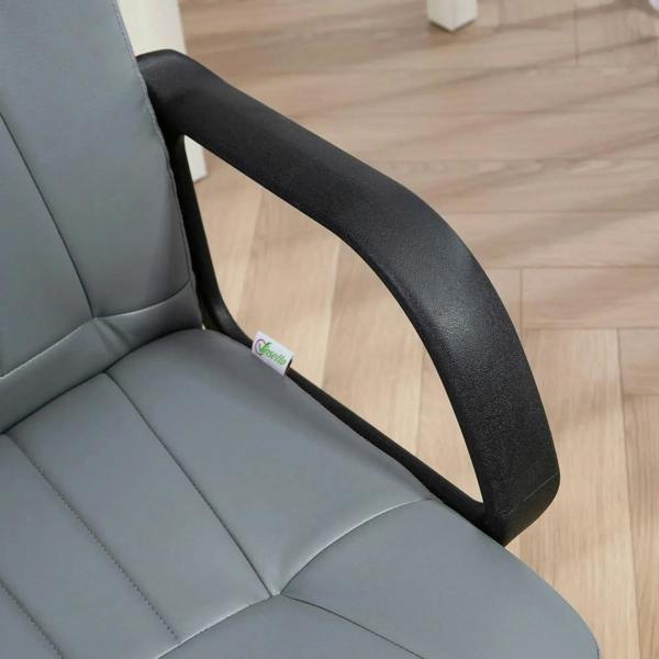 Close-up of grey padded armrest on an office desk chair