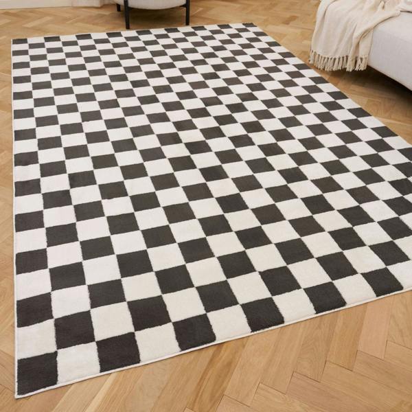 Black and white checkered rug on a wooden floor
