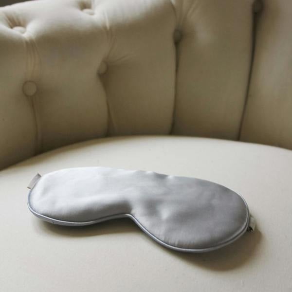 Silk eye mask on a cream sofa