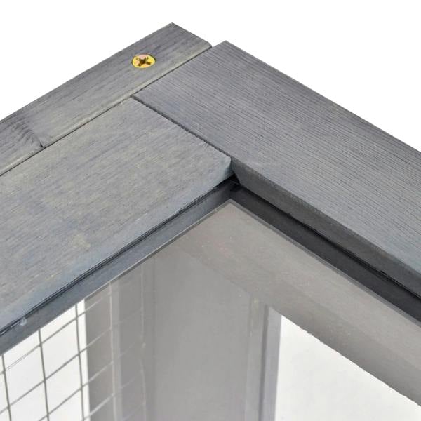 Grey wooden reptile house roof corner with mesh opening and slatted wood panels