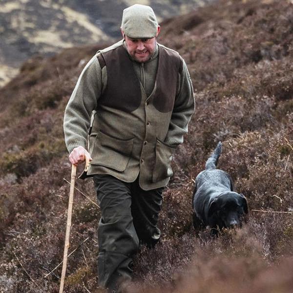 Man with dog wearing Hoggs of Fife Kinloch tweed waistcoat on the moors