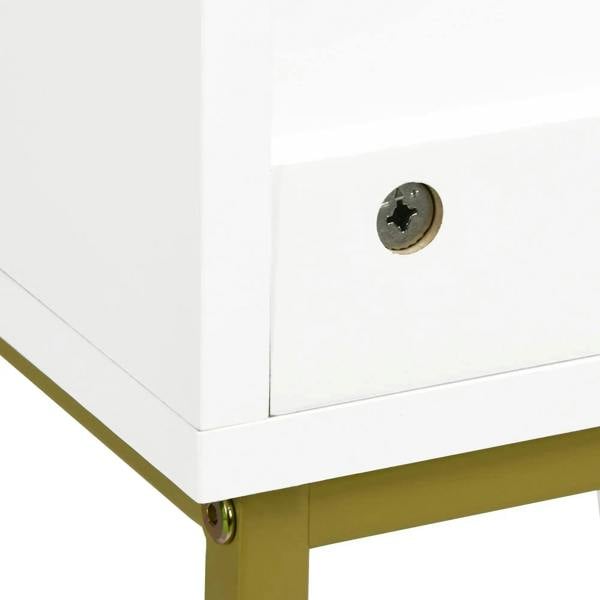 Gold corner leg and base of a white under-sink storage cabinet