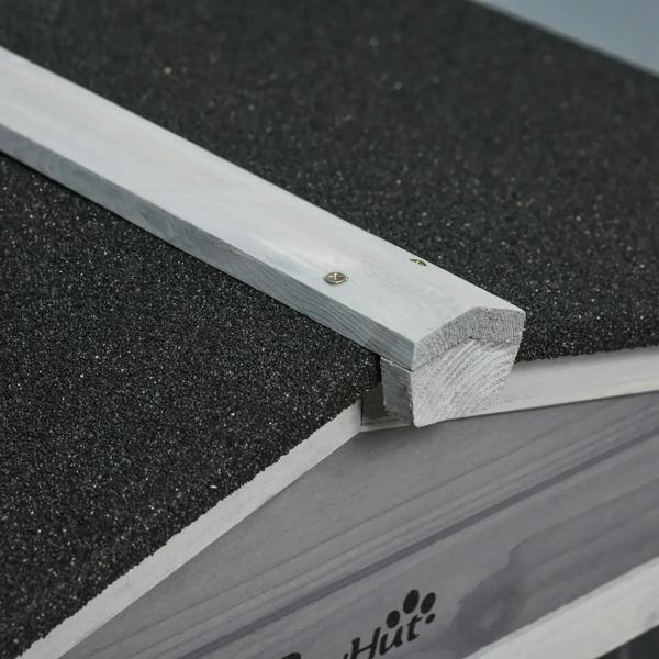 Close-up of black asphalt roof edge on a grey wooden pet ramp