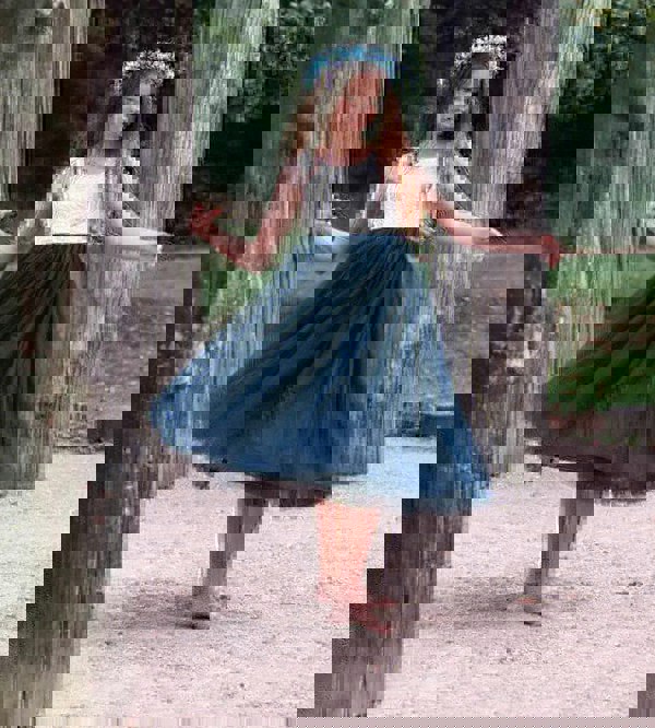 young girl wearing navy blue dress
