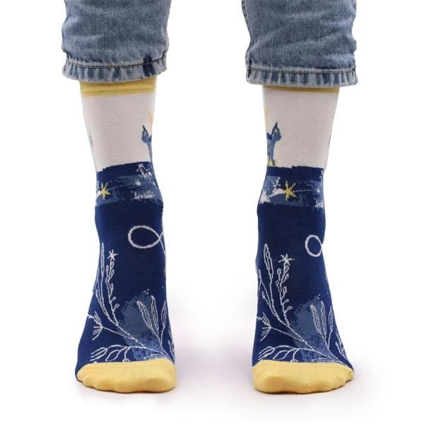 Bamboo socks on legs; navy fabric with yellow cuffs, cat and star constellation design.