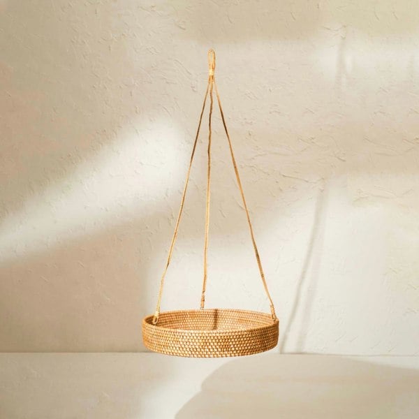 Woven hanging basket on a neutral background