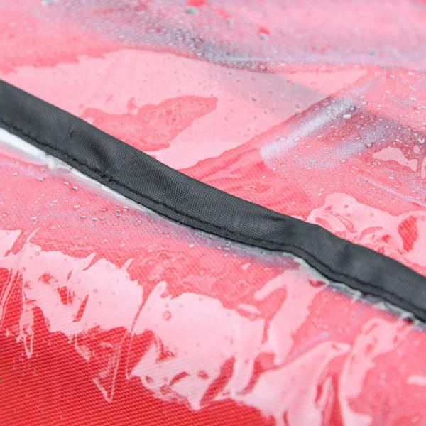 Close-up of red rain cover with black trim and water droplets on the clear surface