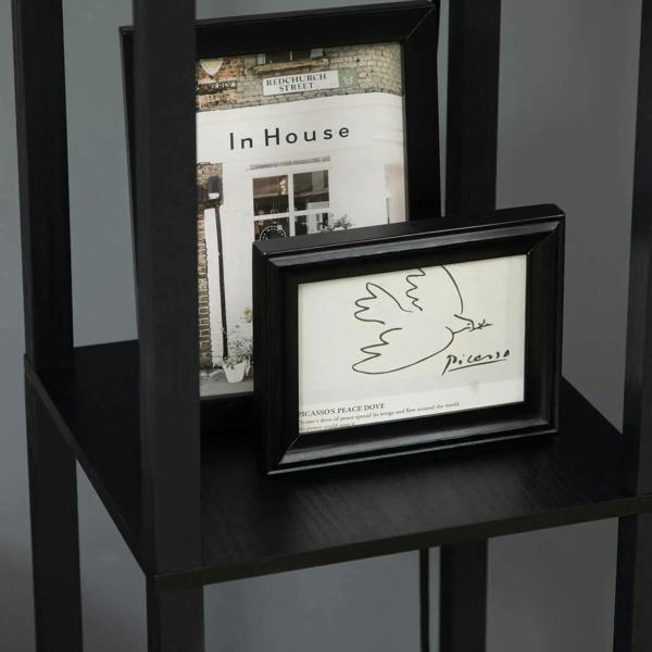 Black floor lamp shelves displaying a framed print at the top section.