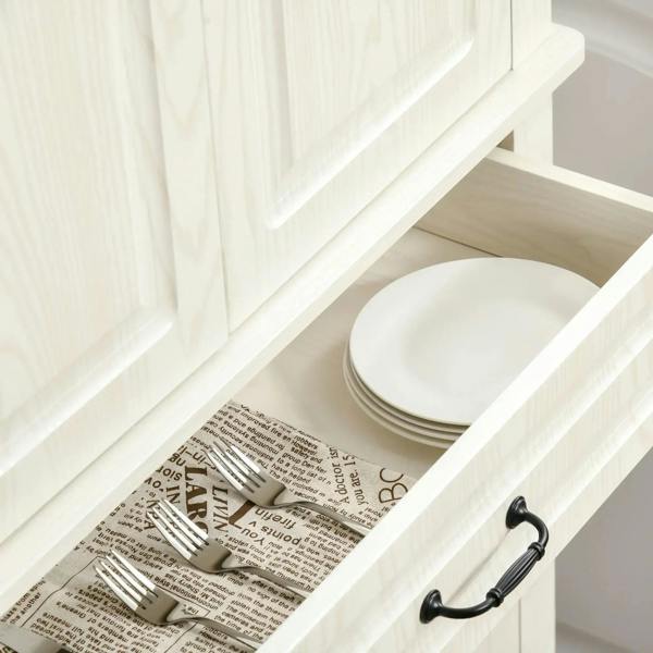 White pull-out drawer with stacked plates and cutlery organizer; black drawer handles