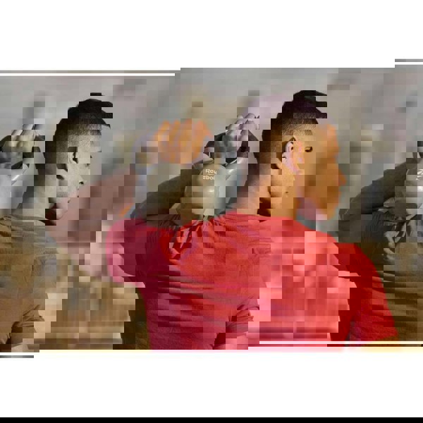 Man holding a Reebok 8kg Cast Iron Kettlebell on his shoulder