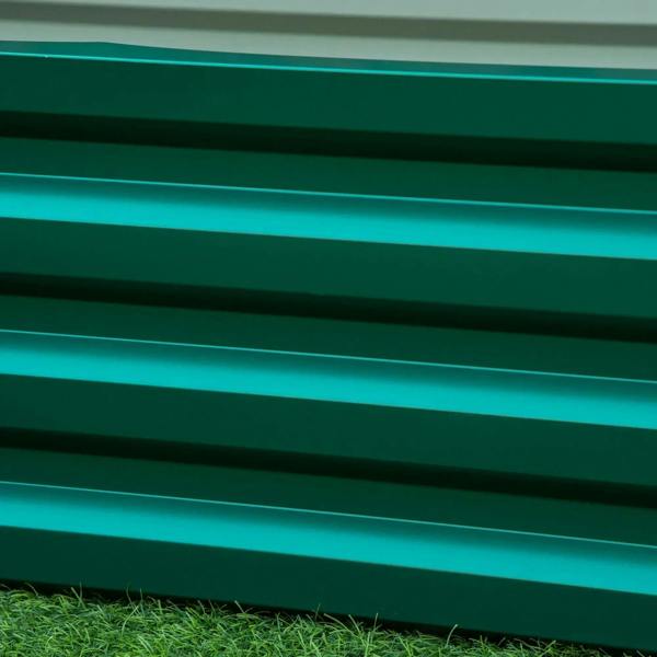 Green raised planter wall with horizontal slat panels and clean edges