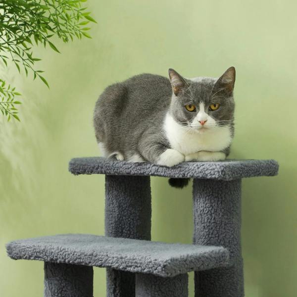 Grey pet stairs with plush steps and posts, cat resting on an upper platform
