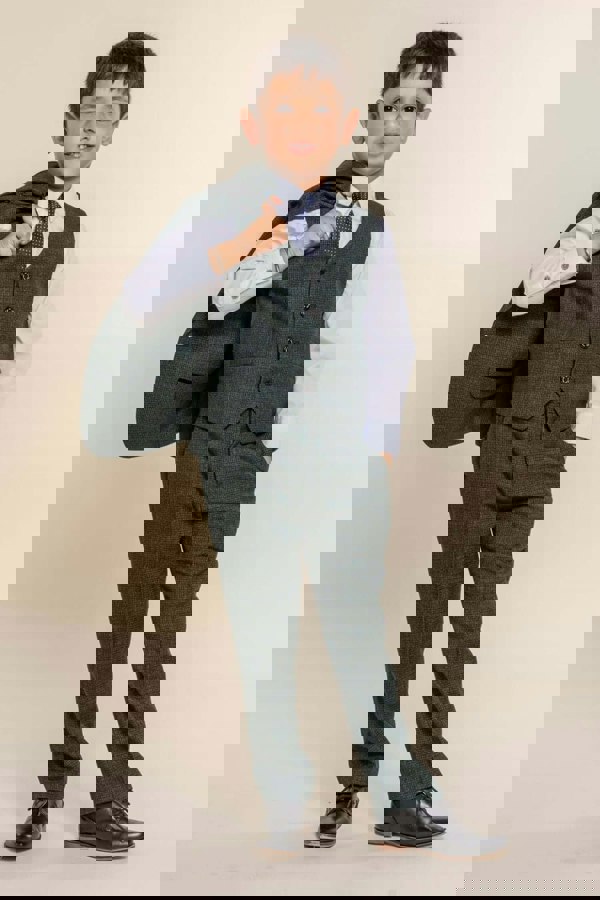 Young boy with jacket slung over shoulder