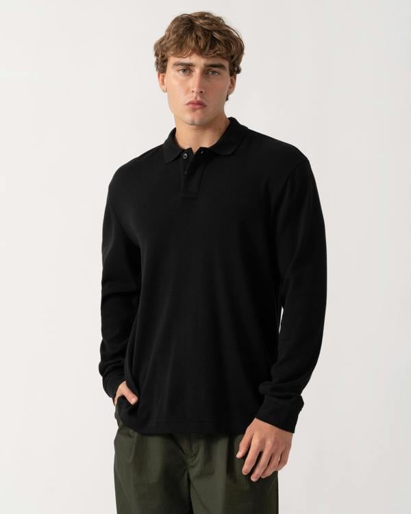 Model wearing BOSS Orange Petempestolong Mens Long Sleeve Polo Shirt - Black 001