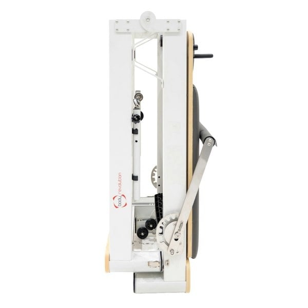 Compact Pilates reformer machine in sleek aluminum, featuring a foldable design, adjustable straps, and a sturdy wooden base