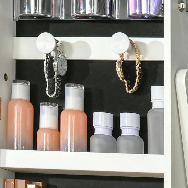 White jewelry cabinet interior with shelves for accessories and hanging earring hooks