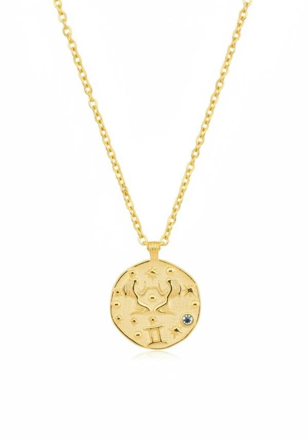 Gold necklace with a round pendant on a white background