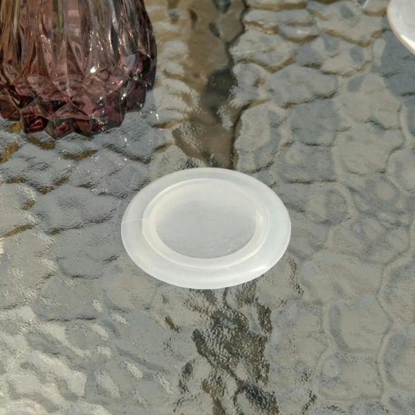 White cover cap for umbrella hole on a black round table with tempered glass top