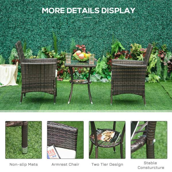 Three-piece brown rattan patio set with armchairs, round glass-top table, white cushions