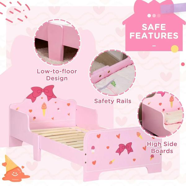 Pink toddler bed with princess bow, hearts and ice-cream patterns; low-to-floor design with safety rails